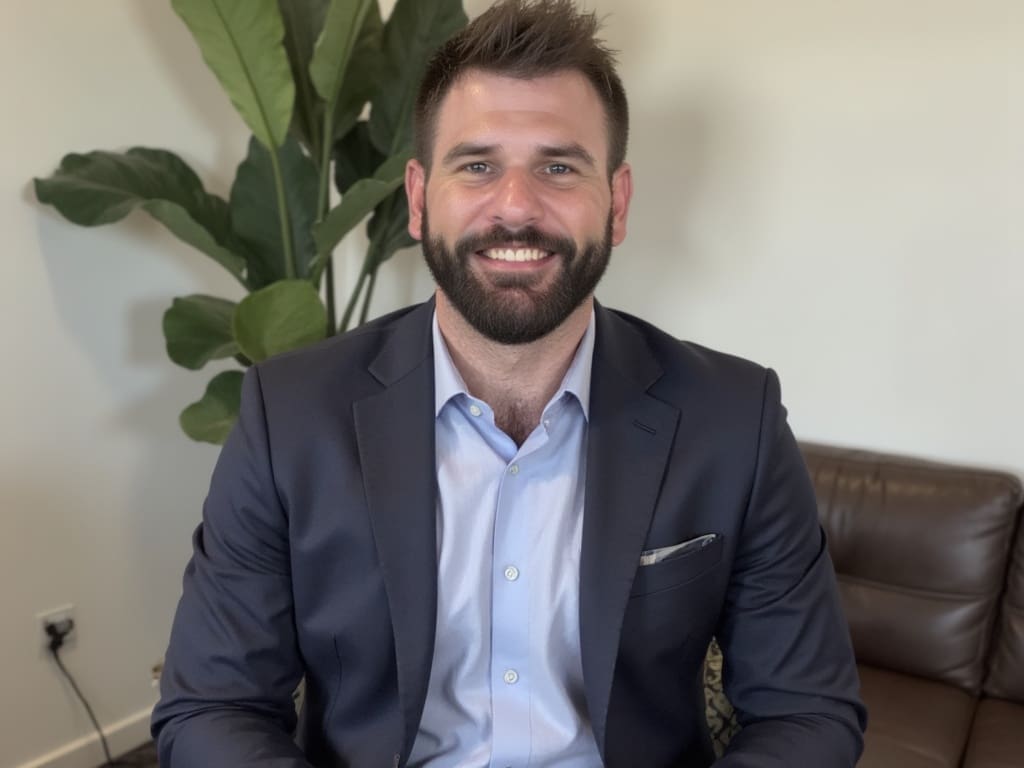 Dr Stuart Cunningham, Brisbane mobile veterinarian, smiling in a blue suit indoors for Personalised Mobile Vet profile photo